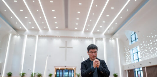Asiatischer Mann in einer Kirche