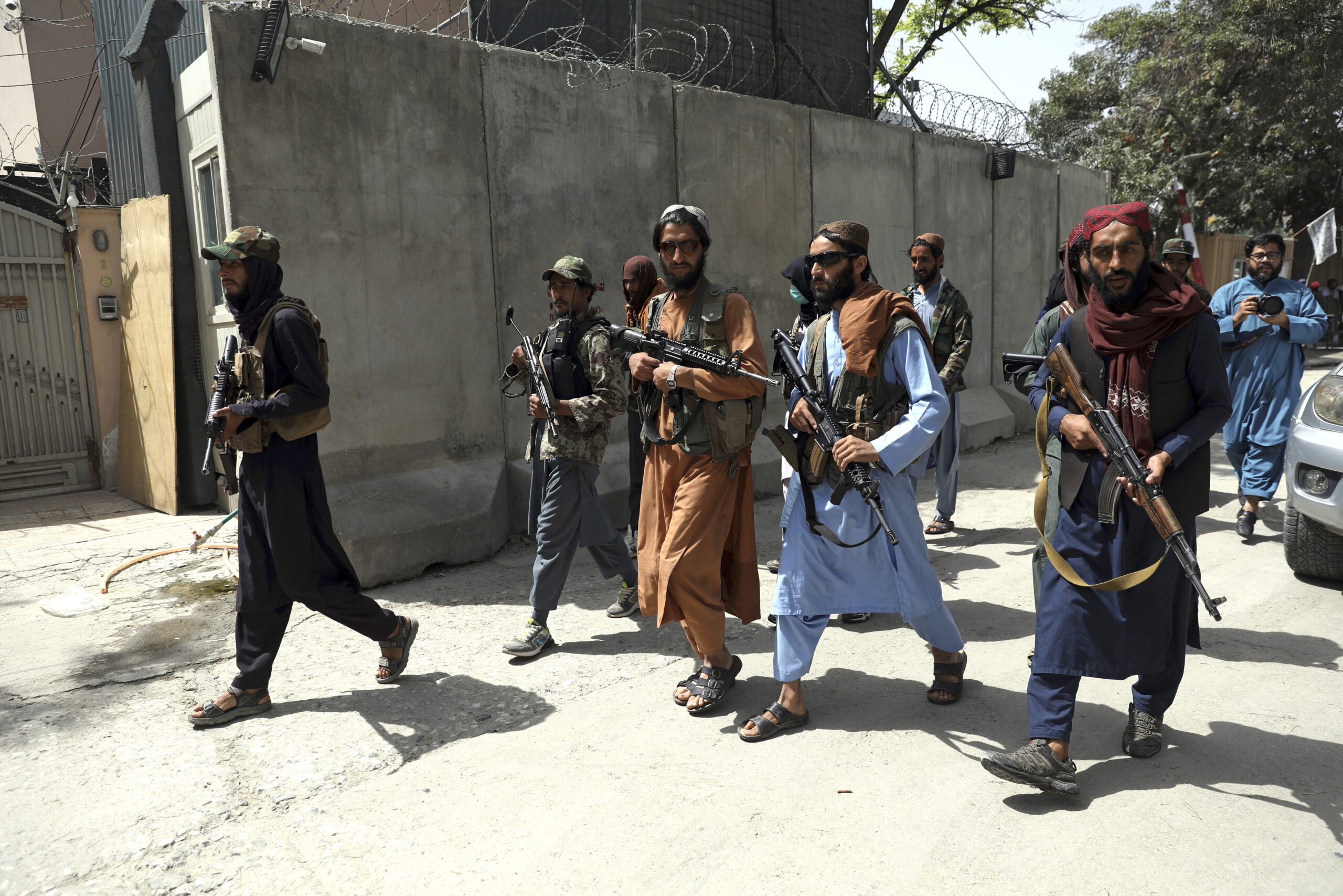 Bewaffenete Taliban-Kämpfer gehen durch die Straßen.